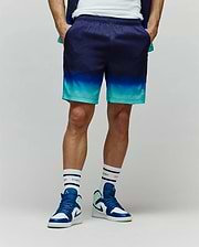 Mens Dax Tencel Short, relaxed fit, featuring a smooth fabric with a dark navy to bright teal gradient, and a small white Psycho Bunny skull logo on the lower right leg.