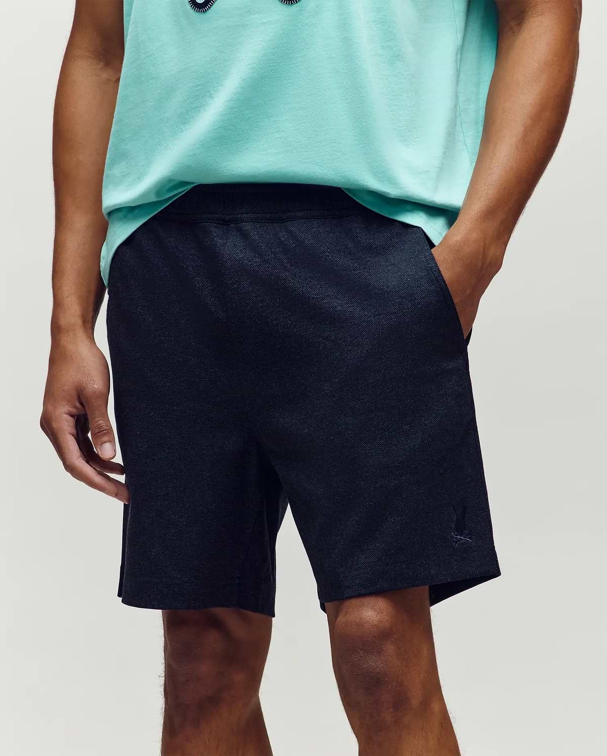 Mens Koda Oxford Short, dark navy heathered knit, relaxed fit shorts with an elastic waistband, side pockets, and a small embroidered Psycho Bunny skull logo on the left leg. (2)