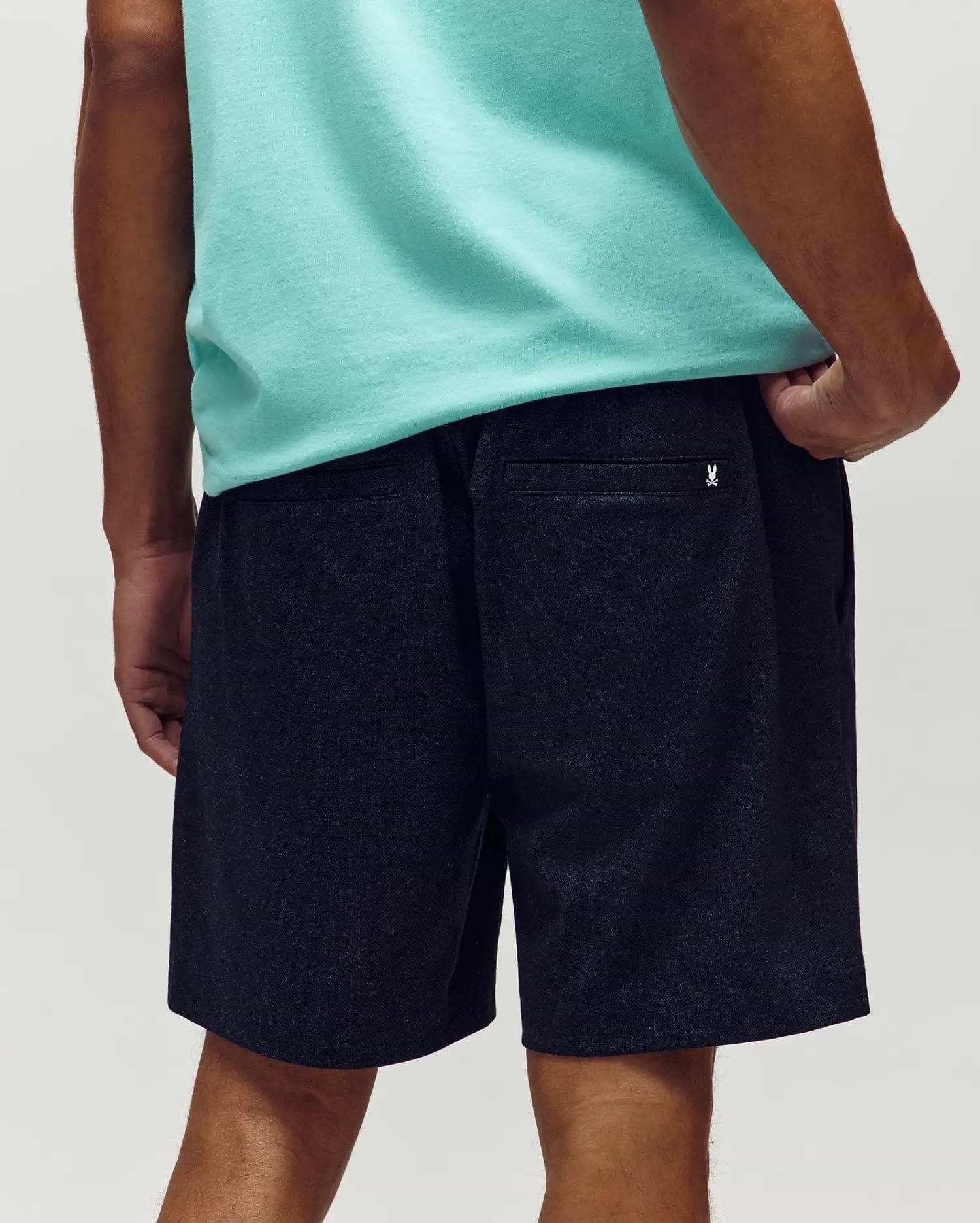 Mens Koda Oxford Short in dark navy textured oxford fabric, featuring a relaxed fit and a small white embroidered Psycho Bunny skull logo on the right rear pocket. (3)