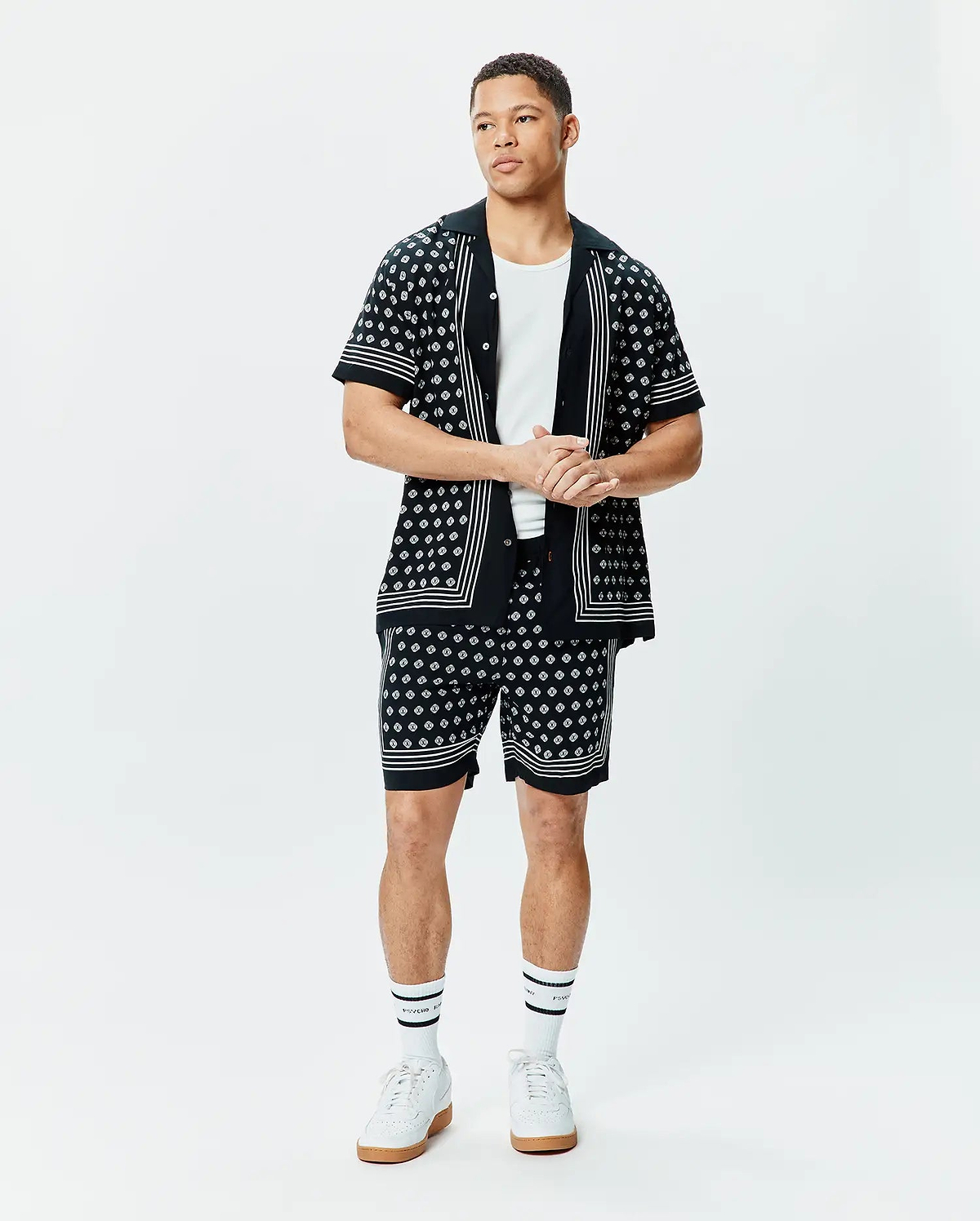 Black short-sleeve button-up shirt and matching Mens Nick Tencel Short 7, both featuring a white geometric pattern, white vertical placket stripes, and white horizontal sleeve/hem stripes, in a relaxed fit.