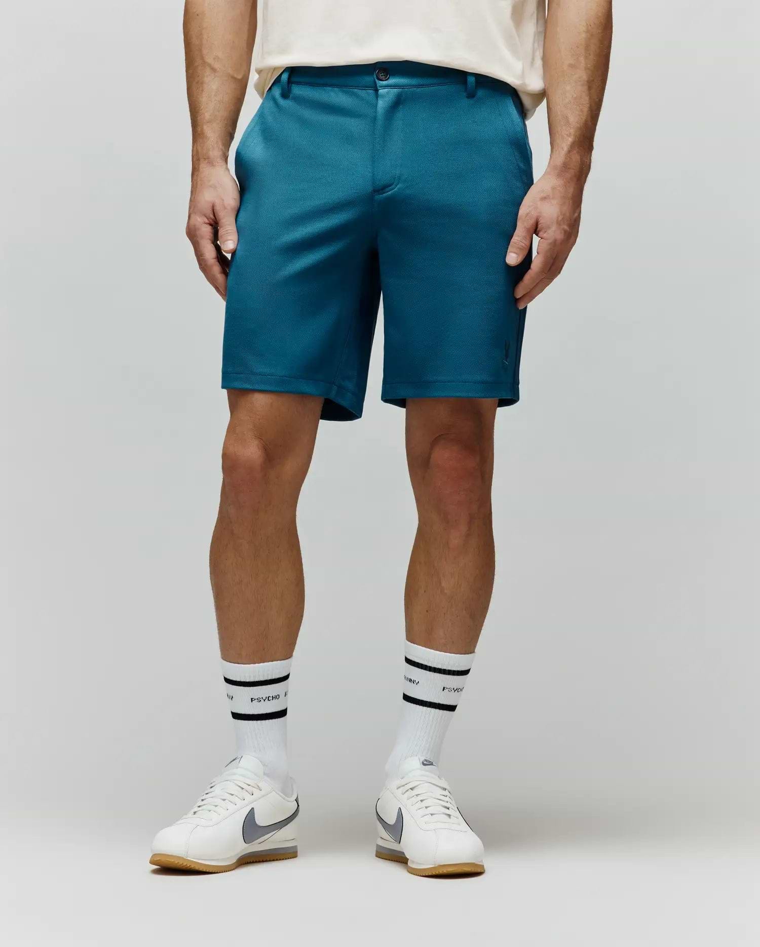 Mens Shiro Twill Short, a classic fit teal twill short with a subtle, tonal embroidered Psycho Bunny skull logo on the lower left leg. (1)