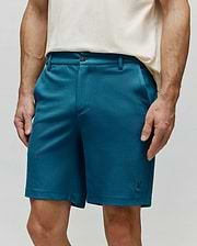 Mens Shiro Twill Short in deep teal blue, featuring a classic fit, visible twill texture, button and zip fly closure, and a small embroidered Psycho Bunny skull logo on the lower left leg. (2)