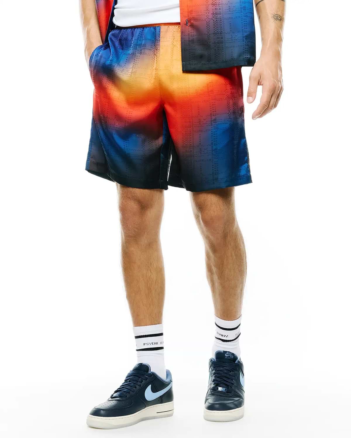 Mens Zander Jacquard Short, a relaxed fit short featuring a vibrant ombre gradient from deep blue to fiery orange, with a subtle woven grid pattern.