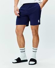 Mens Blaze Sport Short, navy blue classic fit shorts in smooth performance fabric with an elastic waistband, side pockets, and a small white embroidered Psycho Bunny skull logo on the left leg.