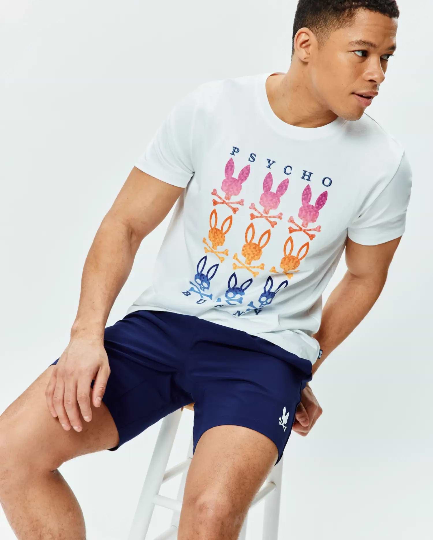 White classic fit jersey t-shirt with a large chest graphic of gradient PSYCHO text and multi-color bunny skull logos, paired with navy Mens Blaze Sport Short with a small white embroidered bunny skull logo on the left leg.