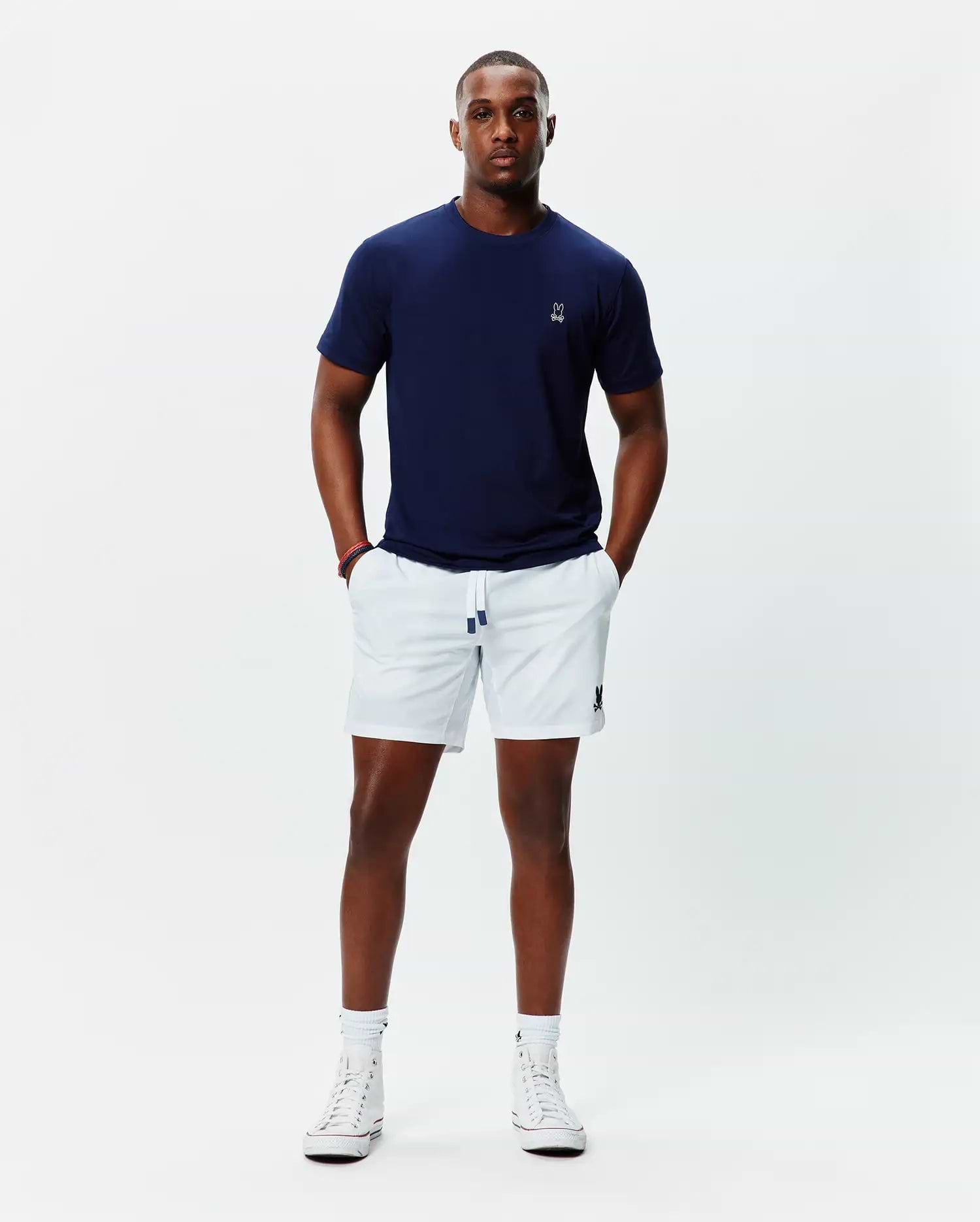 Navy jersey t-shirt with white embroidered Psycho Bunny skull on left chest, and white Mens Blaze Sport Short with navy-tipped drawstring and navy embroidered bunny skull on left leg.