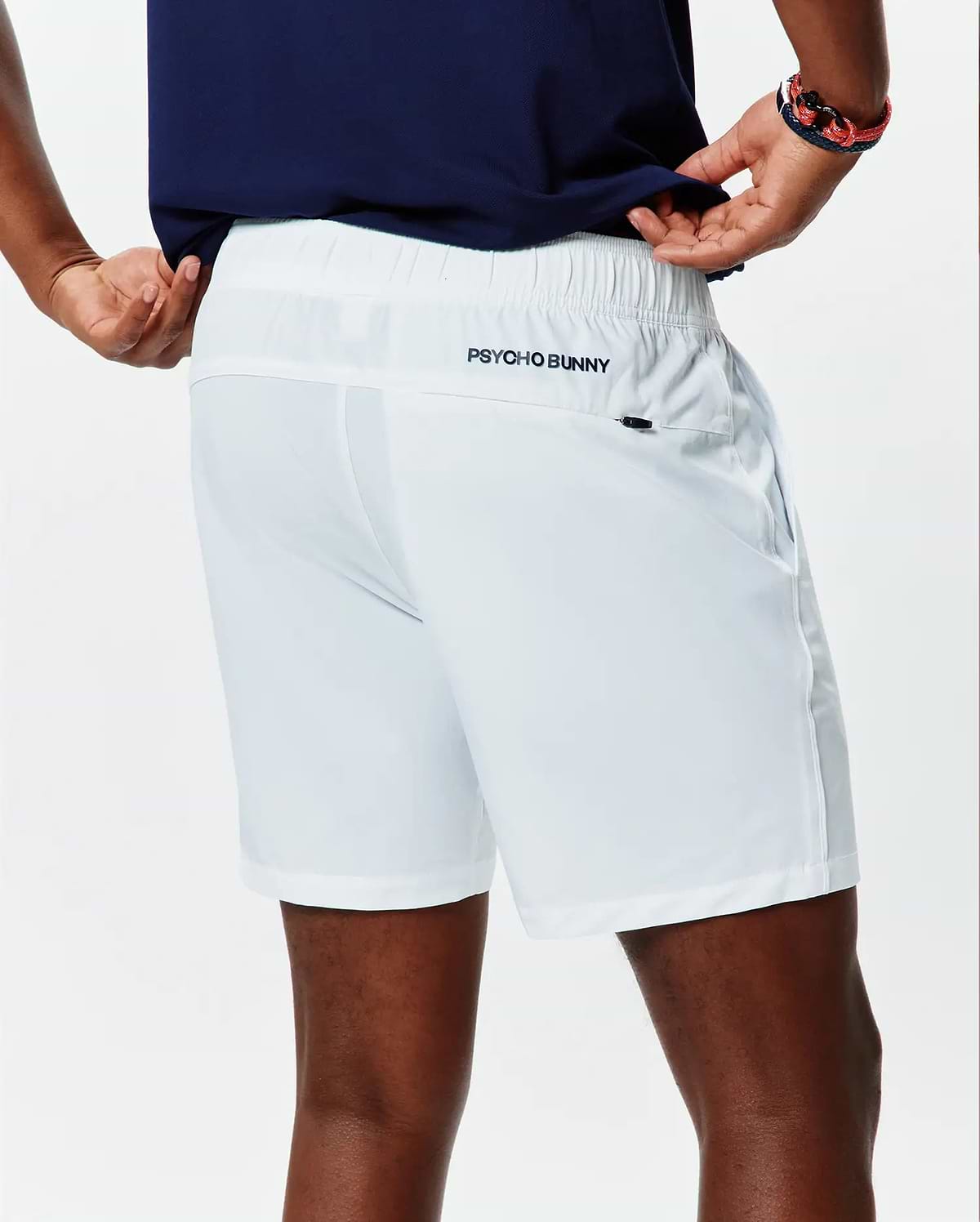 White Mens Blaze Sport Short, classic fit, smooth performance fabric, elastic waistband, side pockets, and a small dark embroidered Psycho Bunny text logo on the upper back right.