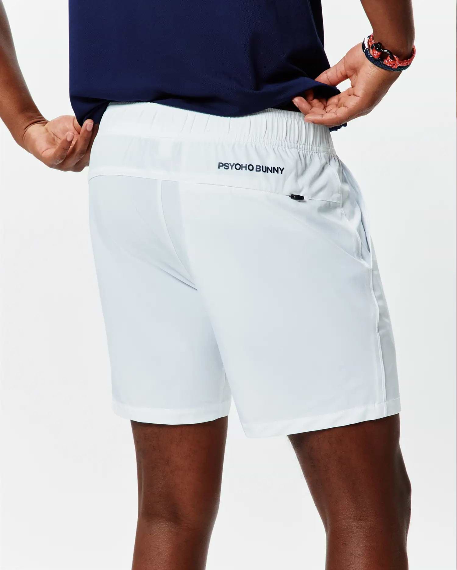 White Mens Blaze Sport Short, classic fit, smooth performance fabric, elastic waistband, side pockets, and a small dark embroidered Psycho Bunny text logo on the upper back right.