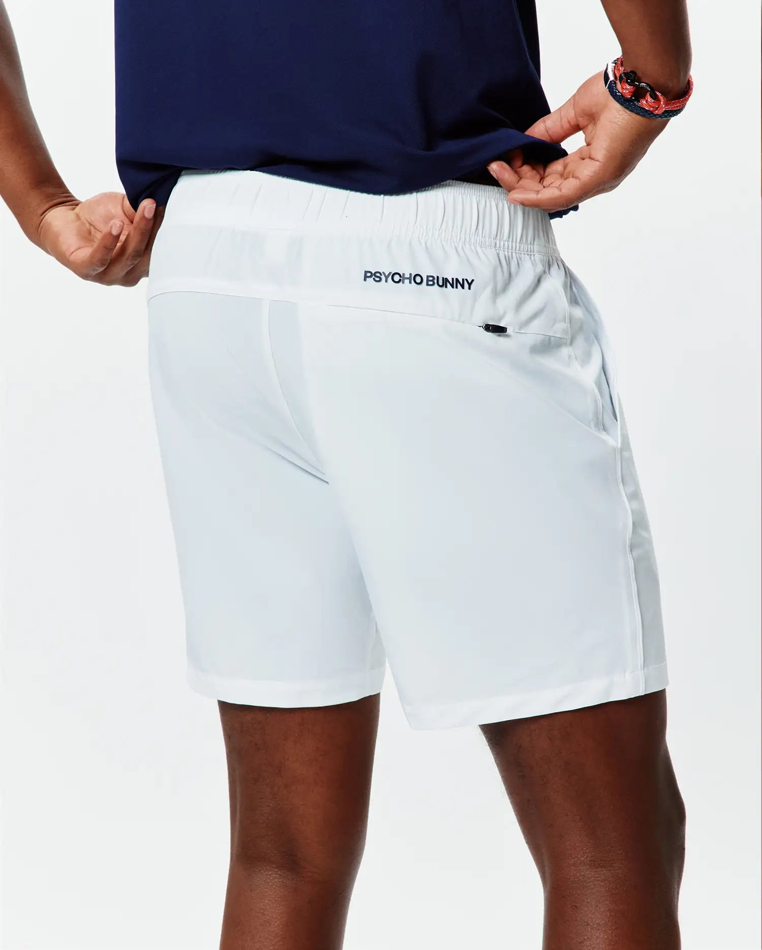 White Mens Blaze Sport Short, classic fit, smooth performance fabric, elastic waistband, side pockets, and a small dark embroidered Psycho Bunny text logo on the upper back right.
