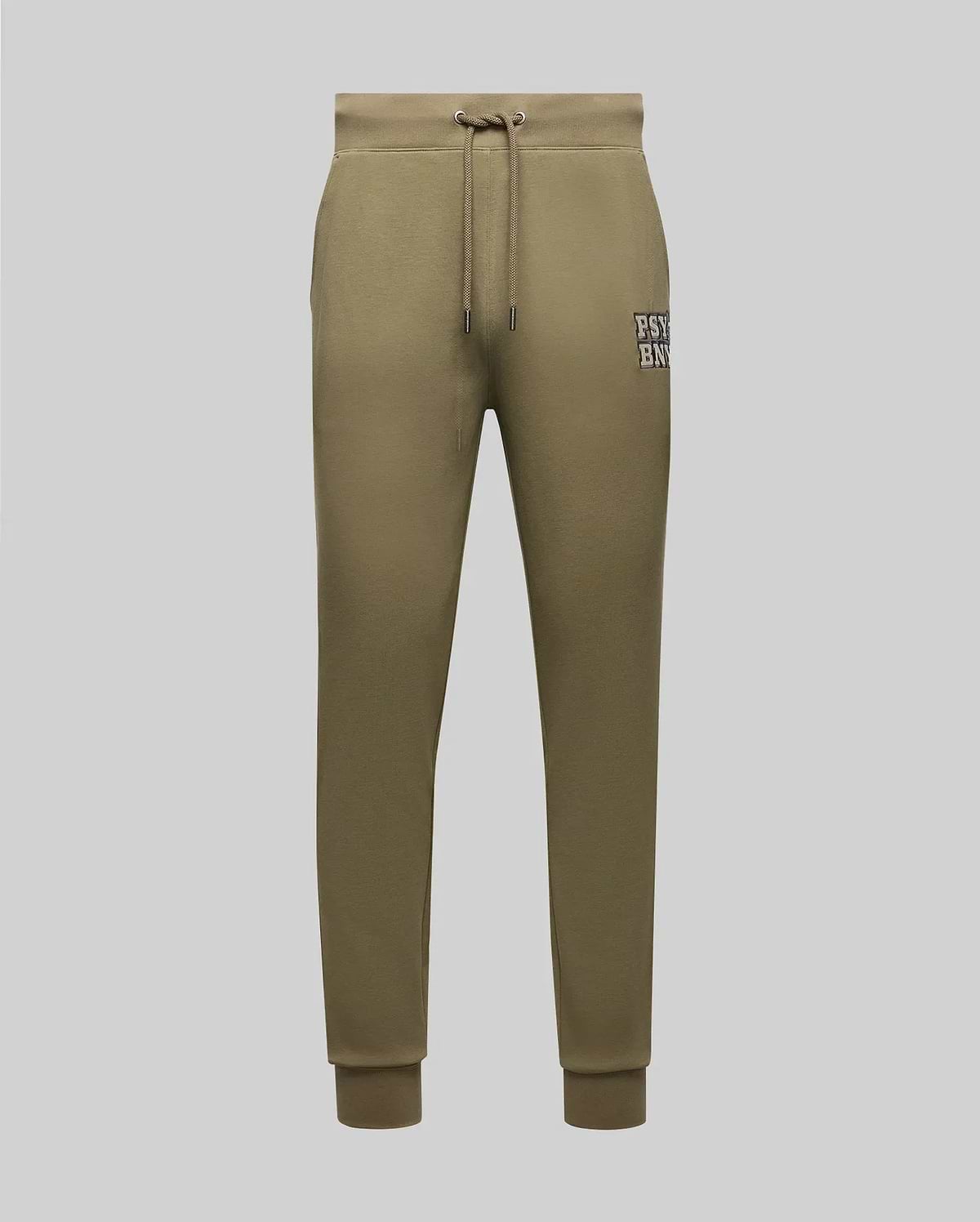 Psycho Bunny’s MENS WADE CORD PATCH SWEATPANT MB0800014 in olive green cotton blend features a drawstring waist, side pockets, rib knit cuffs, and a small “PSY E NYC” patch on the left thigh, shown on a light grey background.