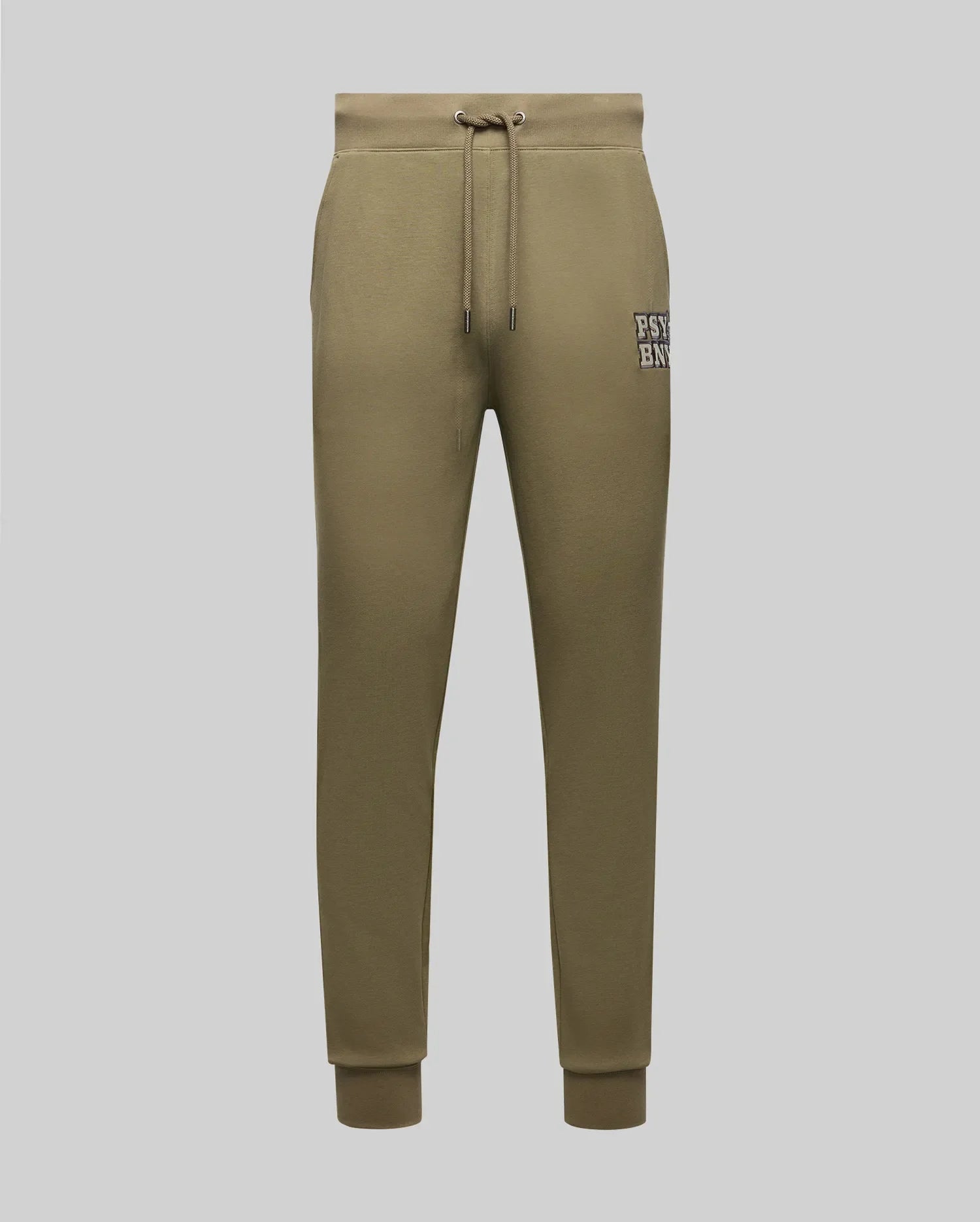 Psycho Bunny’s MENS WADE CORD PATCH SWEATPANT MB0800014 in olive green cotton blend features a drawstring waist, side pockets, rib knit cuffs, and a small “PSY E NYC” patch on the left thigh, shown on a light grey background.