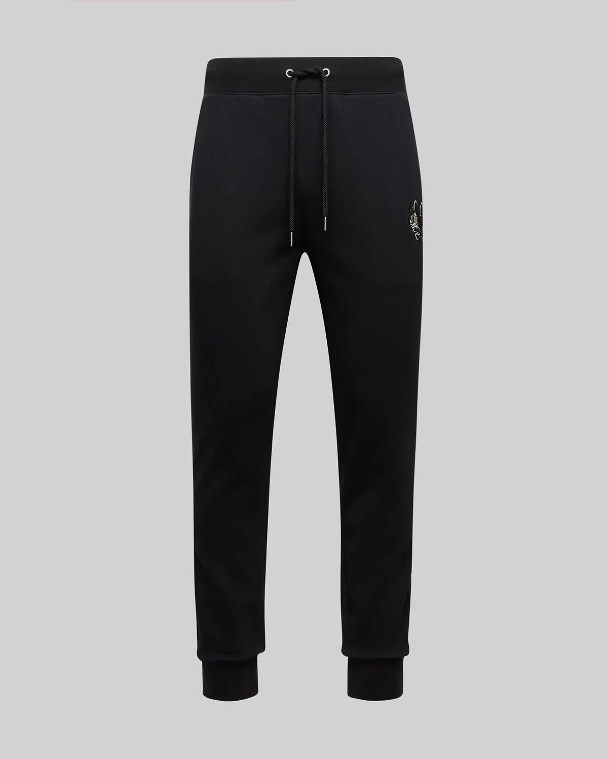 The Psycho Bunny MENS AUGUSTE JOGGER - MB0800015 are black 100% cotton joggers with a drawstring waist, ribbed cuffs, and a small embroidered crest on the left hip, shown against a plain light grey background.
