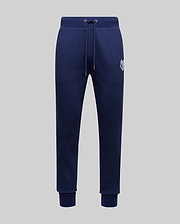 The Psycho Bunny MENS AUGUSTE JOGGER - MB0800015 in navy blue features 100% cotton, a drawstring waistband, side pockets, ribbed cuffs, and a small embroidered logo on the upper left thigh, shown on a light gray background.