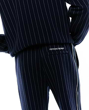 Mens Harland Double Weave Chalk Stripe Track Pant, navy with fine white pinstripes, a relaxed fit, and a prominent white side stripe. White embroidered PSYCHO BUNNY branding is on the back flap pocket. (4)