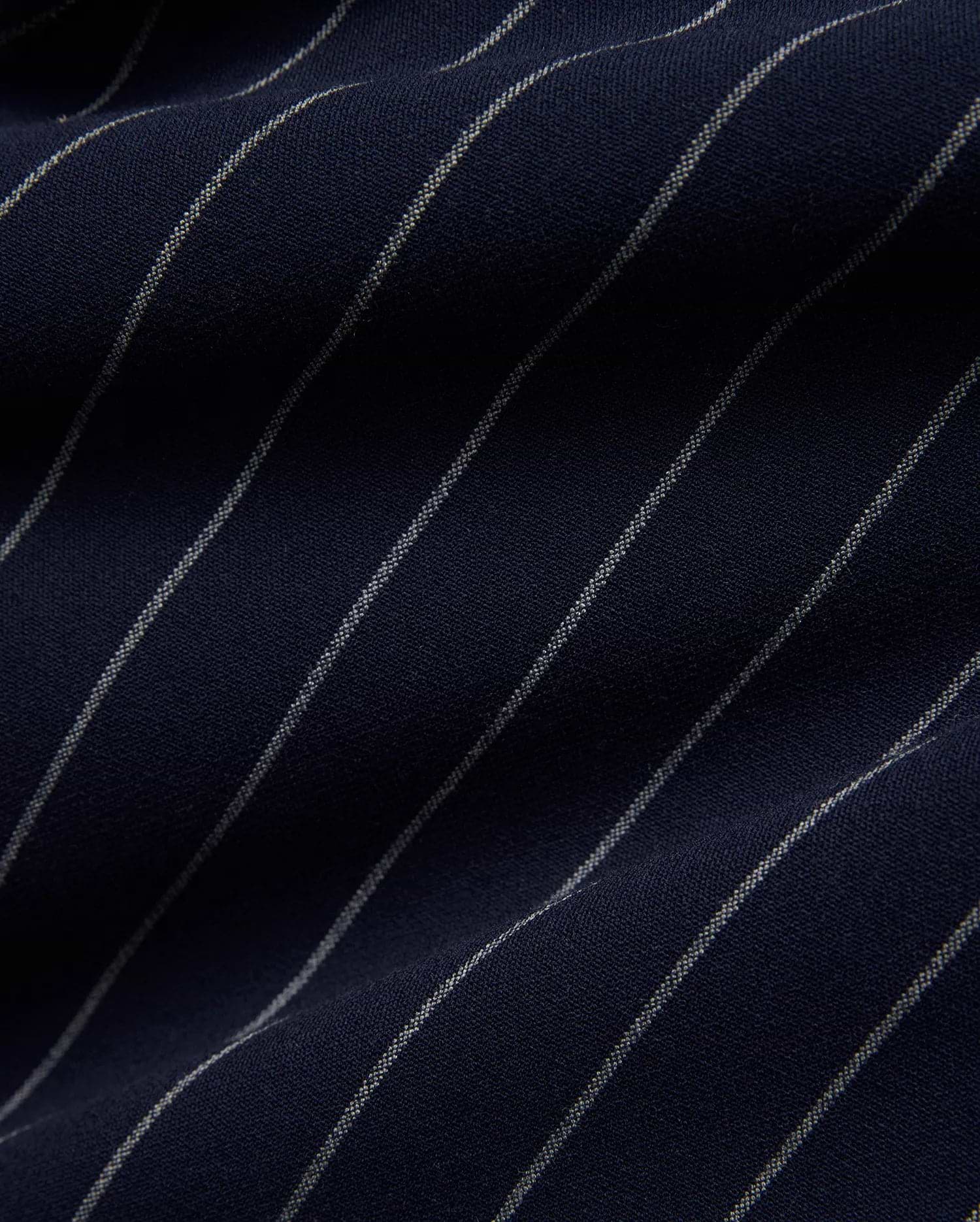 Mens Harland Double Weave Chalk Stripe Track Pant in deep navy blue, featuring fine, textured white chalk stripes woven into the fabric, highlighting its premium double weave texture. (6)
