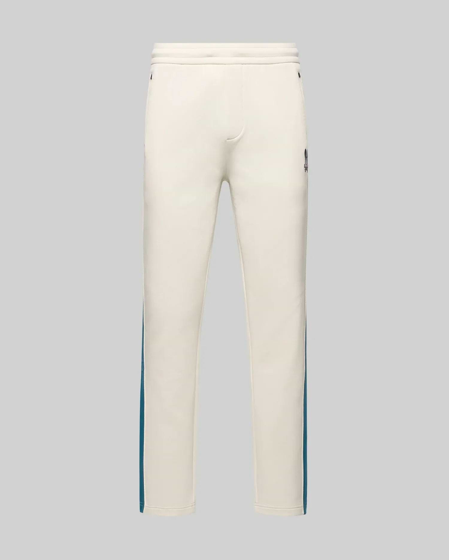 Mens Caspian Track Pant in cream smooth jersey, featuring a relaxed fit, teal side stripes, and a small embroidered Psycho Bunny skull logo on the upper right thigh. (5)