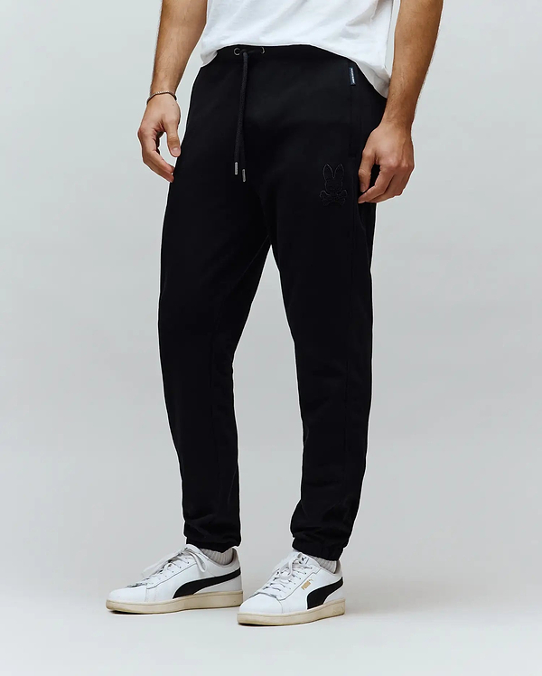 Black Mens Barry Joggers in a relaxed, tapered fit, crafted from soft jersey knit fabric. Features a tonal embroidered Psycho Bunny skull logo on the left thigh and a drawstring waist with silver tips.