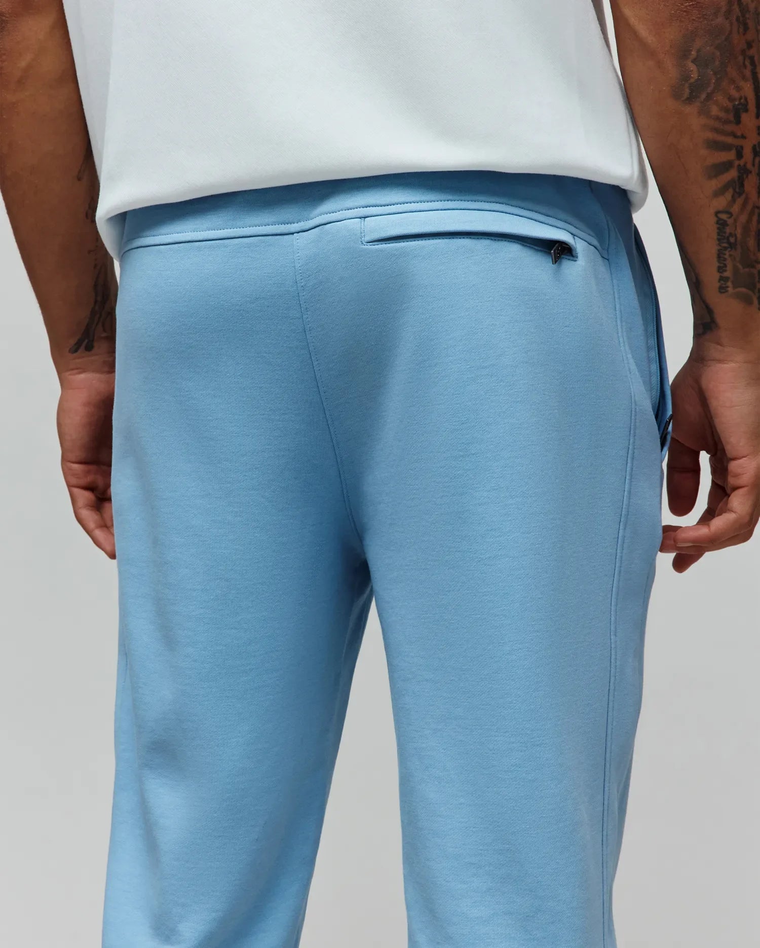 Mens Barry Joggers in light blue, crafted from soft french terry with a classic fit, featuring a ribbed waistband and a discreet zippered back pocket. (3)