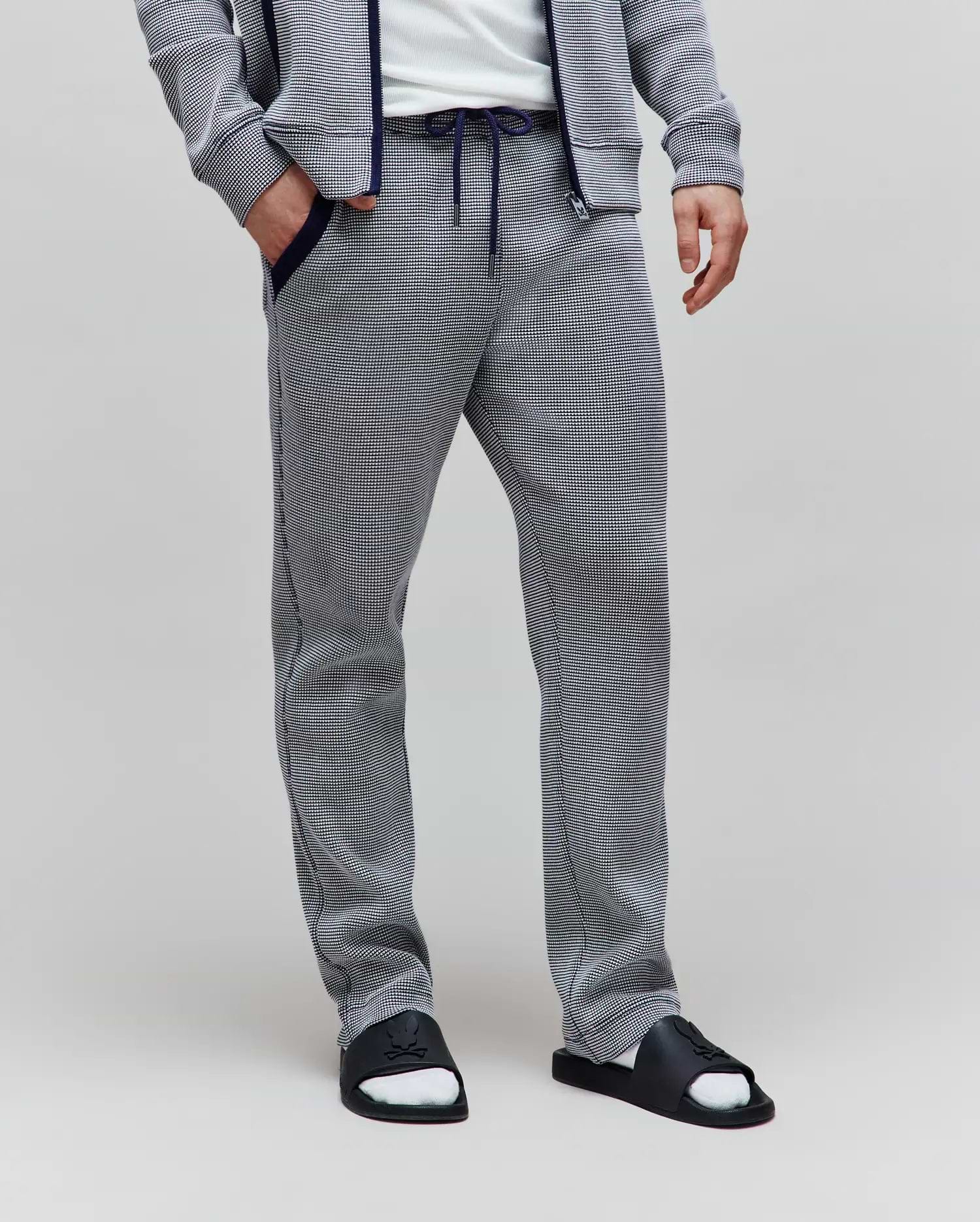 Mens Maxton Two Tone Jogger in a navy and white micro-patterned textured knit, featuring a relaxed fit, navy drawstring waist, and navy trimmed side pockets.