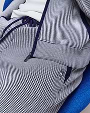 Mens Maxton Two Tone Jogger in navy blue and white two-tone textured knit, featuring a relaxed fit, navy drawstrings, zippered pocket, and small embroidered Psycho Bunny skull logo on the left hip.