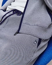 Mens Maxton Two Tone Jogger in navy blue and white two-tone textured knit, featuring a relaxed fit, navy drawstrings, zippered pocket, and small embroidered Psycho Bunny skull logo on the left hip.