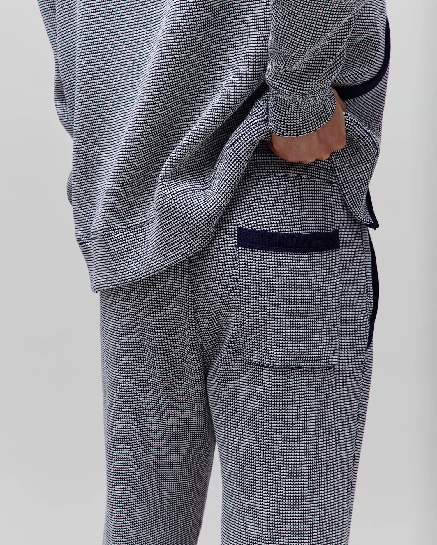 Mens Maxton Two Tone Jogger in a navy and white micro-pattern knit, with a relaxed fit, solid navy side piping, ribbed cuffs, and a back pocket with navy trim.
