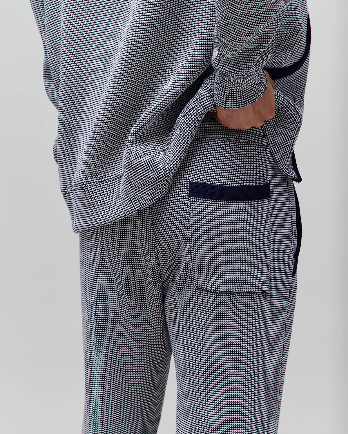 Mens Maxton Two Tone Jogger in a navy and white micro-pattern knit, with a relaxed fit, solid navy side piping, ribbed cuffs, and a back pocket with navy trim.