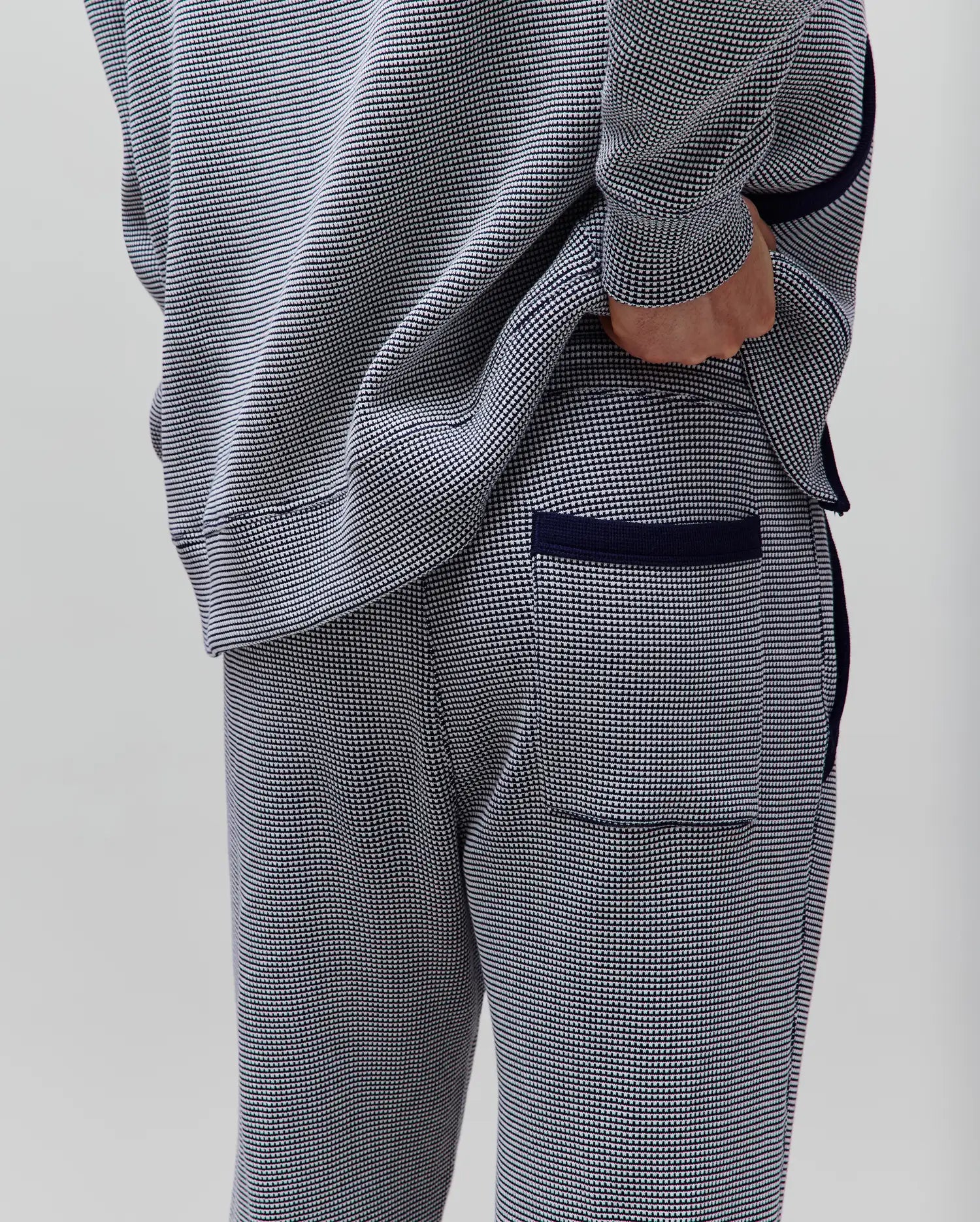 Mens Maxton Two Tone Jogger in a navy and white micro-pattern knit, with a relaxed fit, solid navy side piping, ribbed cuffs, and a back pocket with navy trim.