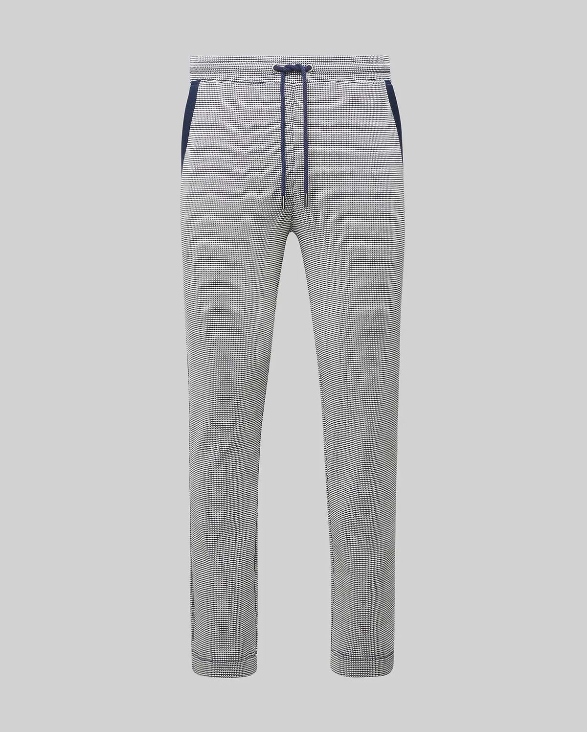 Mens Maxton Two Tone Jogger, a slim fit jogger in a white and black micro-patterned textured knit, featuring a navy blue drawstring, waistband, and side pocket trim.