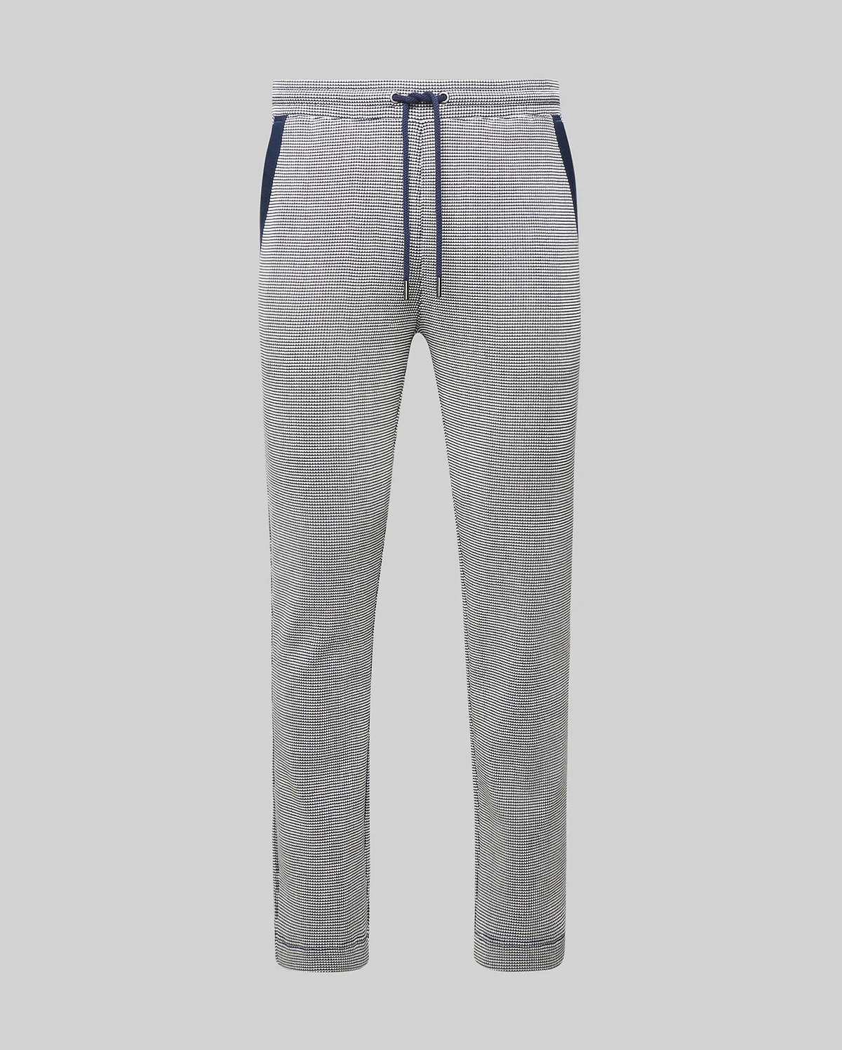 Mens Maxton Two Tone Jogger, a slim fit jogger in a white and black micro-patterned textured knit, featuring a navy blue drawstring, waistband, and side pocket trim.