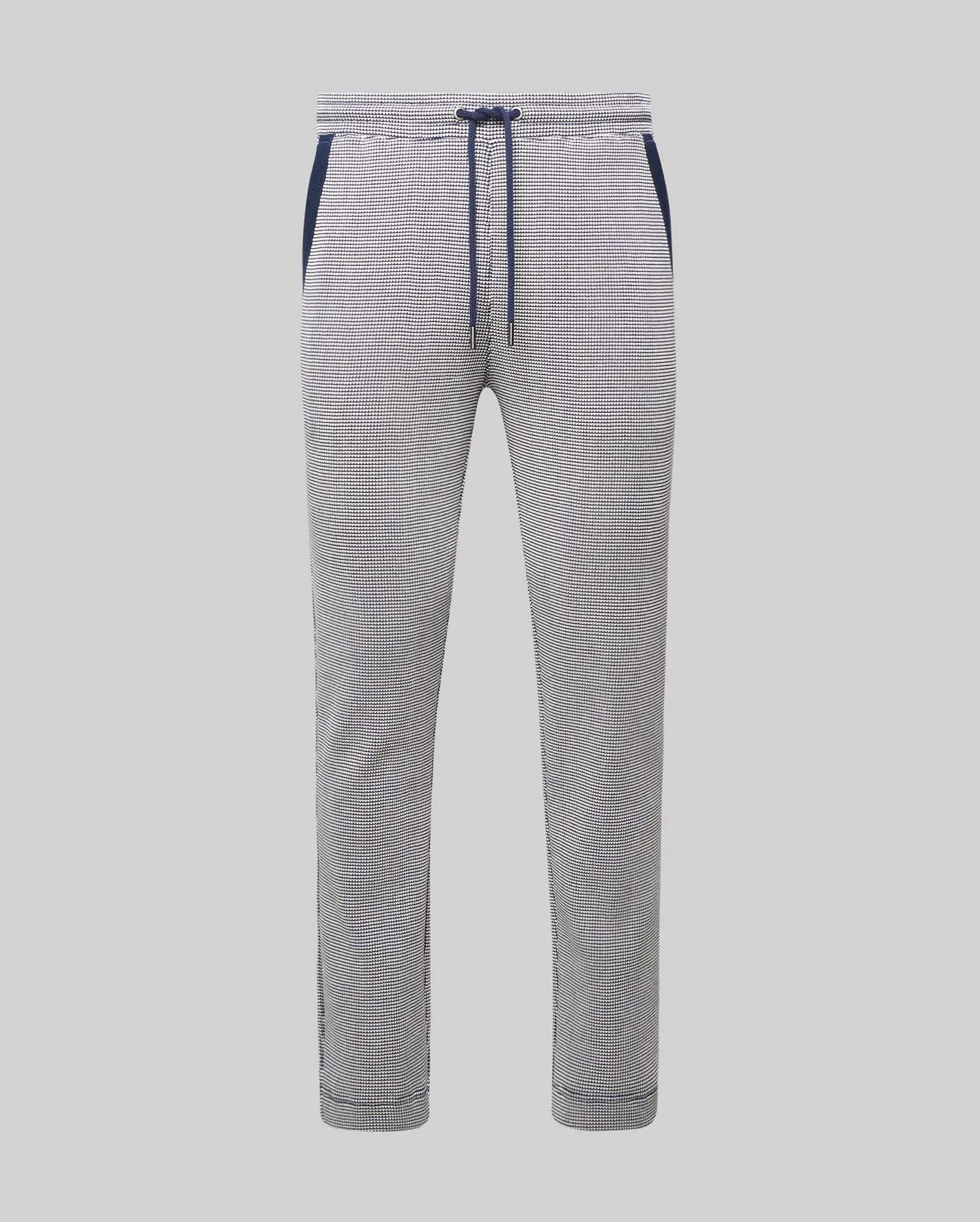 Mens Maxton Two Tone Jogger, a slim fit jogger in a white and black micro-patterned textured knit, featuring a navy blue drawstring, waistband, and side pocket trim.