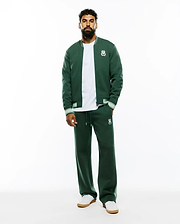 Psycho Bunny dark green french terry bomber jacket with white striped ribbed trim and embroidered logo, white jersey t-shirt, and Mens Jaydon Track Pant, relaxed fit, with drawstring waist and embroidered logo. (4)