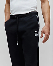 Mens Toby Track Pants, black relaxed fit French terry with white side stripes, white drawstring, and an embroidered white Psycho Bunny skull logo on the left thigh.