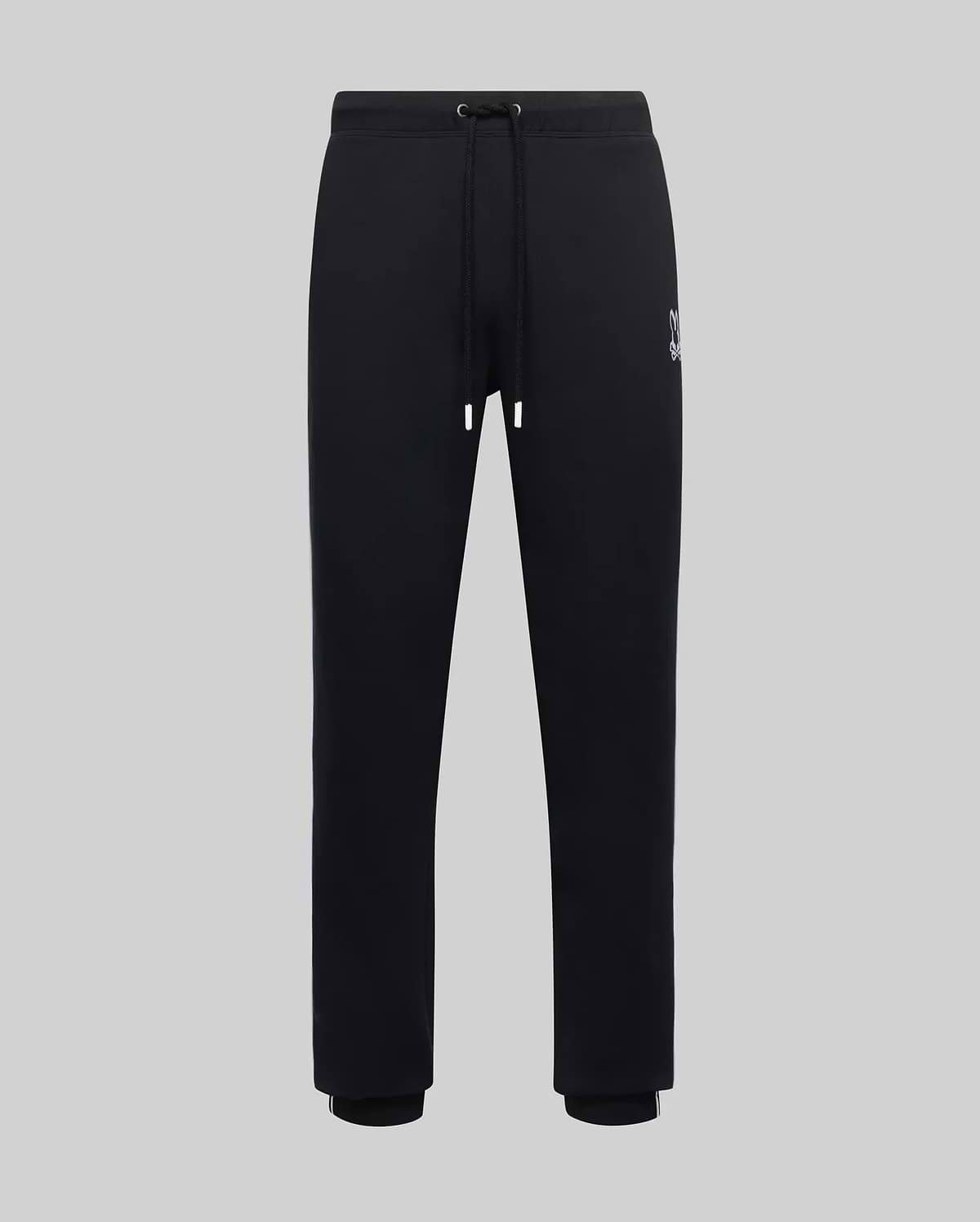 Mens Toby Track Pants, black smooth jersey with a relaxed fit, featuring a small embroidered white Psycho Bunny skull logo on the left thigh, drawstring waist, and ribbed cuffs with a white stripe.