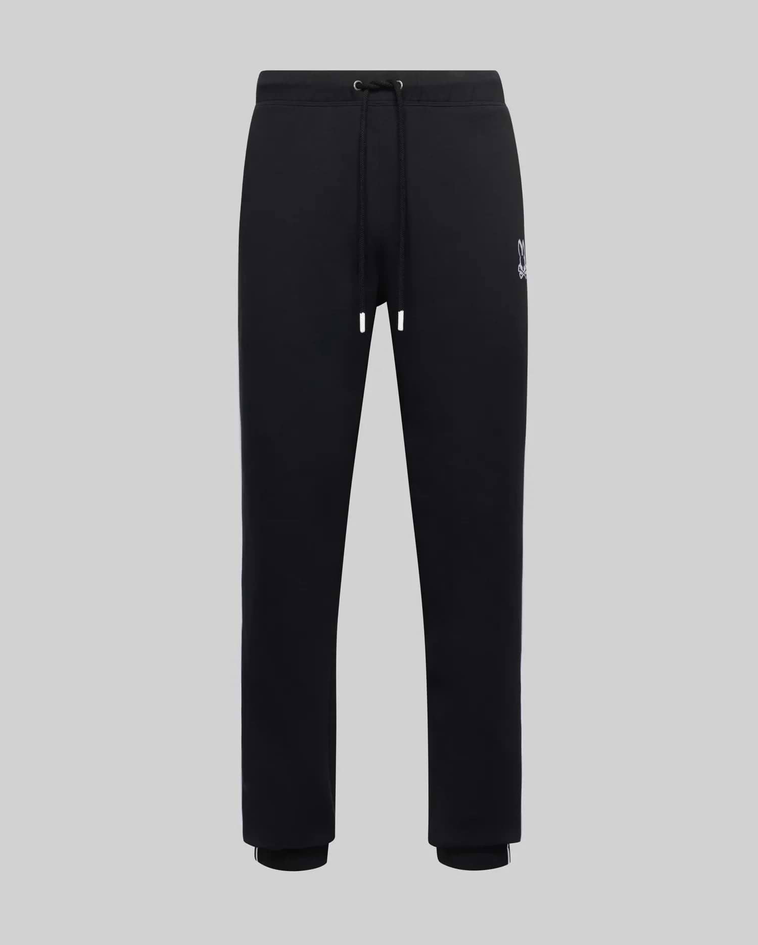 Mens Toby Track Pants, black smooth jersey with a relaxed fit, featuring a small embroidered white Psycho Bunny skull logo on the left thigh, drawstring waist, and ribbed cuffs with a white stripe.