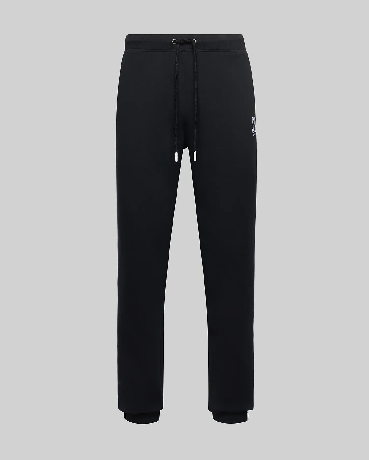 Mens Toby Track Pants, black smooth jersey with a relaxed fit, featuring a small embroidered white Psycho Bunny skull logo on the left thigh, drawstring waist, and ribbed cuffs with a white stripe.