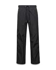 Mens Alder Nylon Colorblock Pant in black crinkled nylon, offering a relaxed fit with a drawstring waist and distinct olive green side stripes.