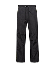 Mens Alder Nylon Colorblock Pant in black crinkled nylon, offering a relaxed fit with a drawstring waist and distinct olive green side stripes.