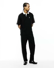 Black pique polo with white collar, sleeve stripes, and small embroidered Psycho Bunny logo, paired with Mens Ceano Track Pant, black with white side piping and a small bunny skull.