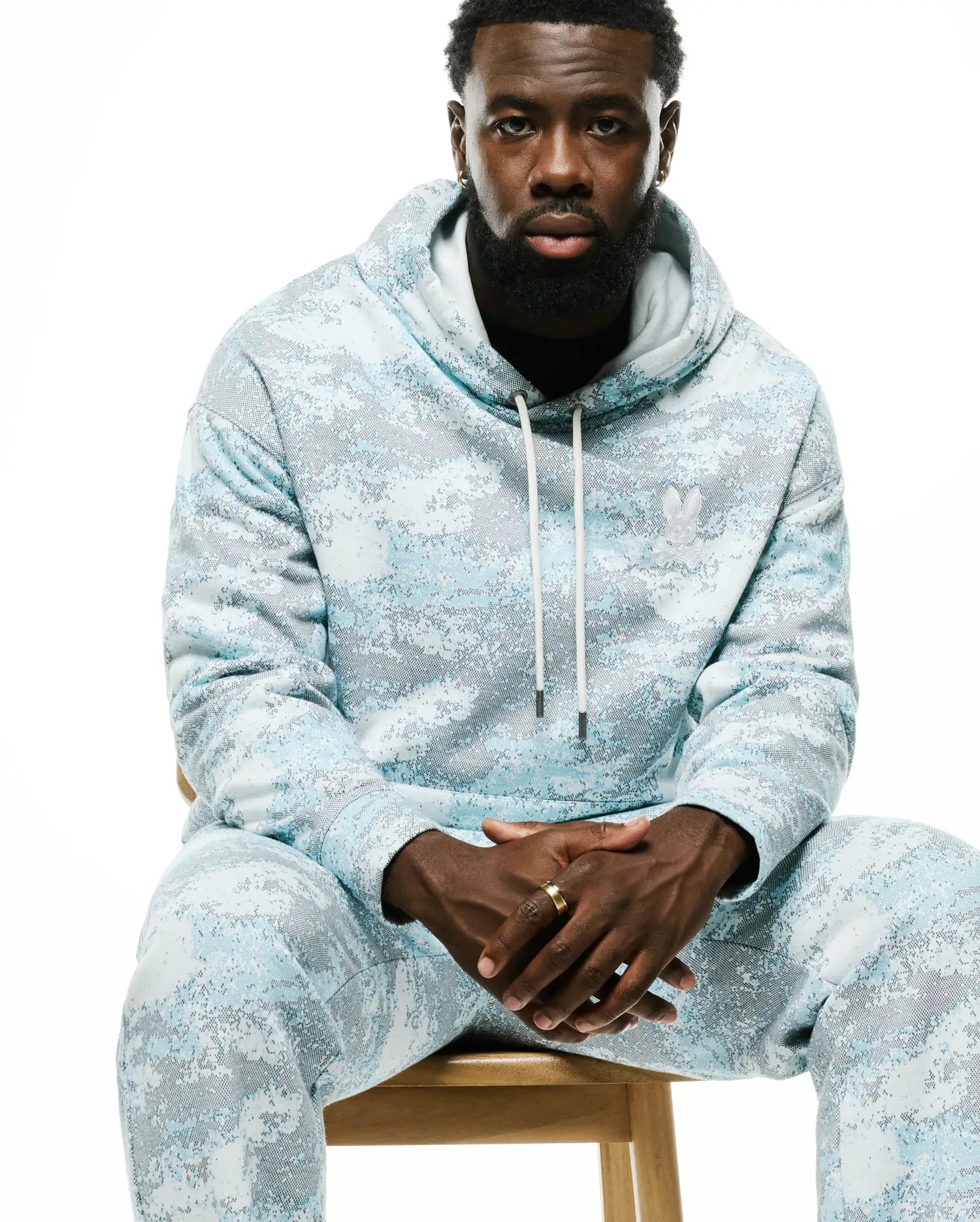 Relaxed fit light blue and grey pixelated Psycho Bunny hoodie and matching Men's Alfie Graphic Sweatpants, featuring a small white embroidered bunny skull logo on the chest. (4)