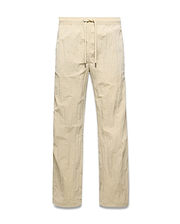 Mens Alder Nylon Pant in light beige with a crinkled nylon texture, featuring a relaxed straight-leg fit and an elasticated drawstring waist. (5)