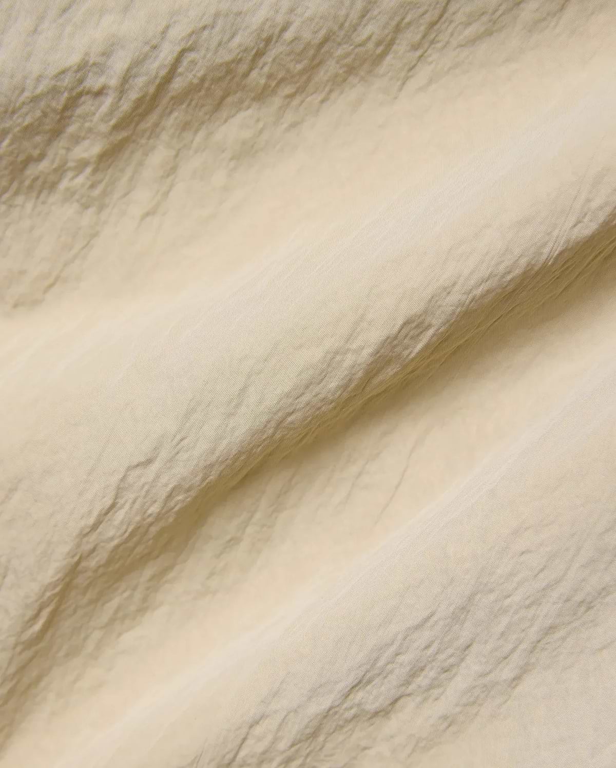 Mens Alder Nylon Pant in a sophisticated light beige hue, showcasing its premium, subtly textured and crinkled nylon fabric with a refined, fine weave, ideal for refined streetwear. (6)