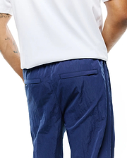MENS ALDER NYLON PANT in deep navy blue, showcasing a distinctive crinkled nylon fabric texture, a comfortable relaxed fit, and practical rear flap pockets. (2)