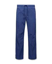 Mens Alder Nylon Pant in deep blue, featuring a relaxed straight leg fit, crinkled nylon fabric, and an elasticated drawstring waist with metallic tips. (5)