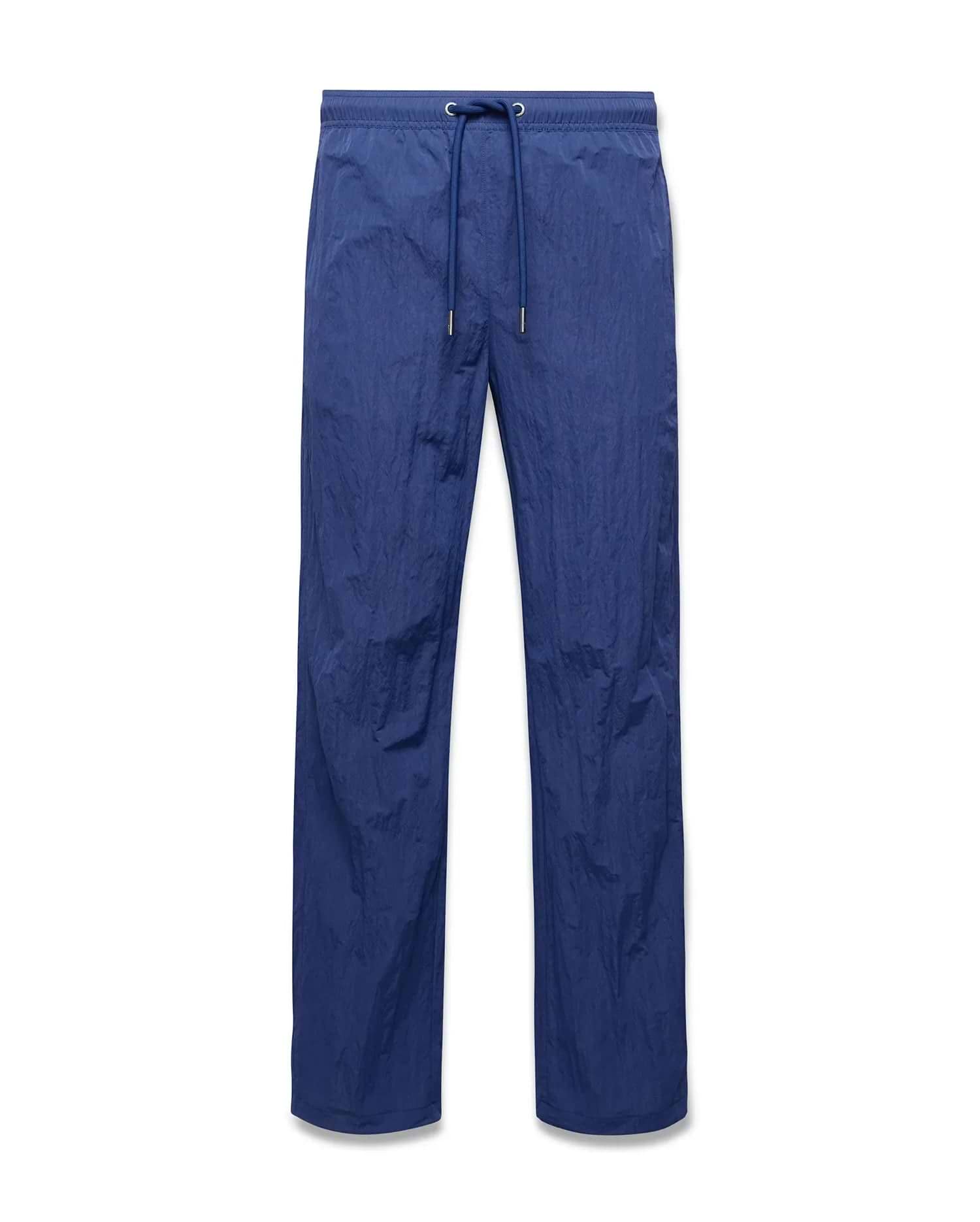 Mens Alder Nylon Pant in deep blue, featuring a relaxed straight leg fit, crinkled nylon fabric, and an elasticated drawstring waist with metallic tips. (5)