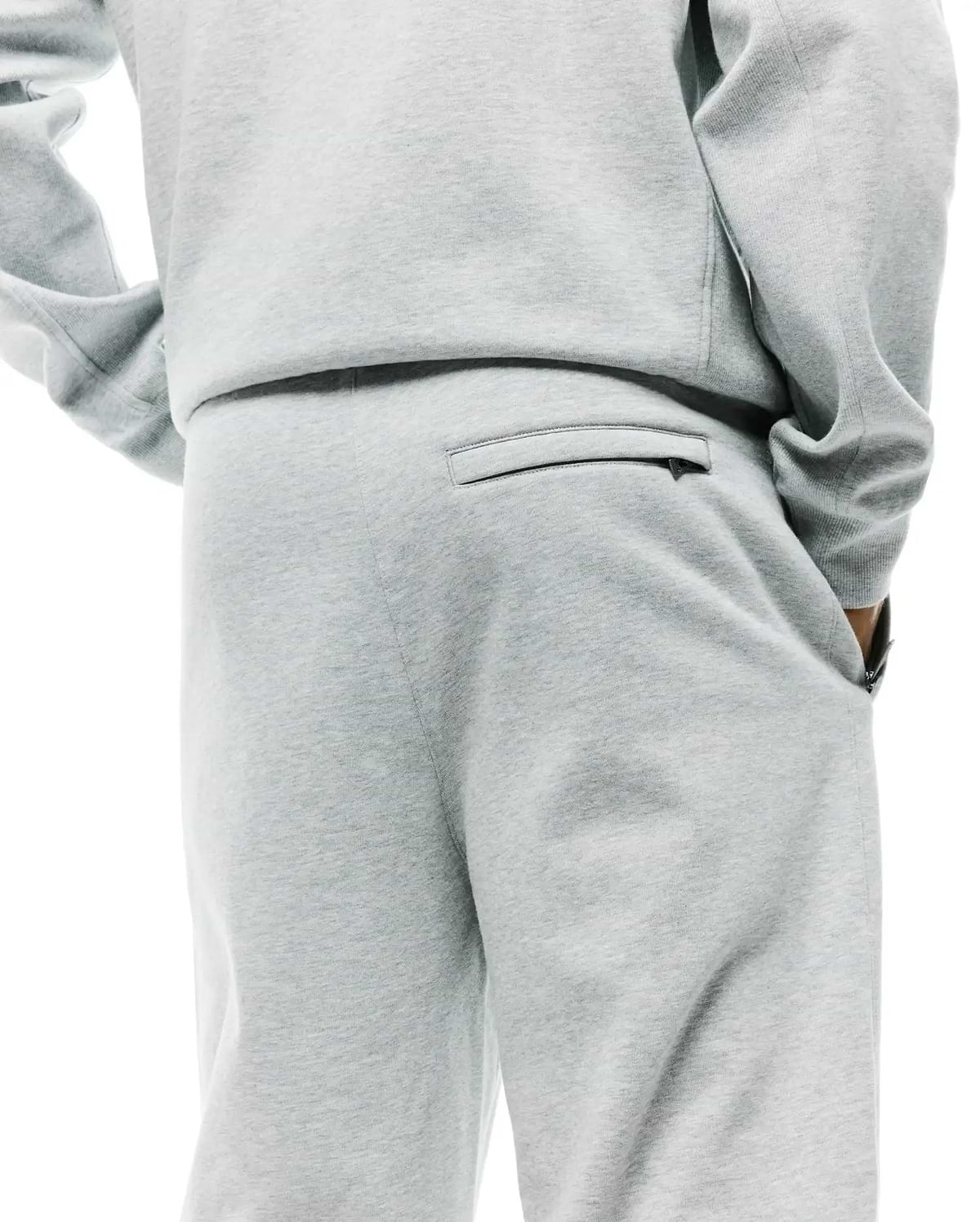 Mens Terrence Brushed Fleece Sweatpant in light grey marl, offering a relaxed fit, soft brushed fleece texture, a zippered back pocket, and convenient side pockets.