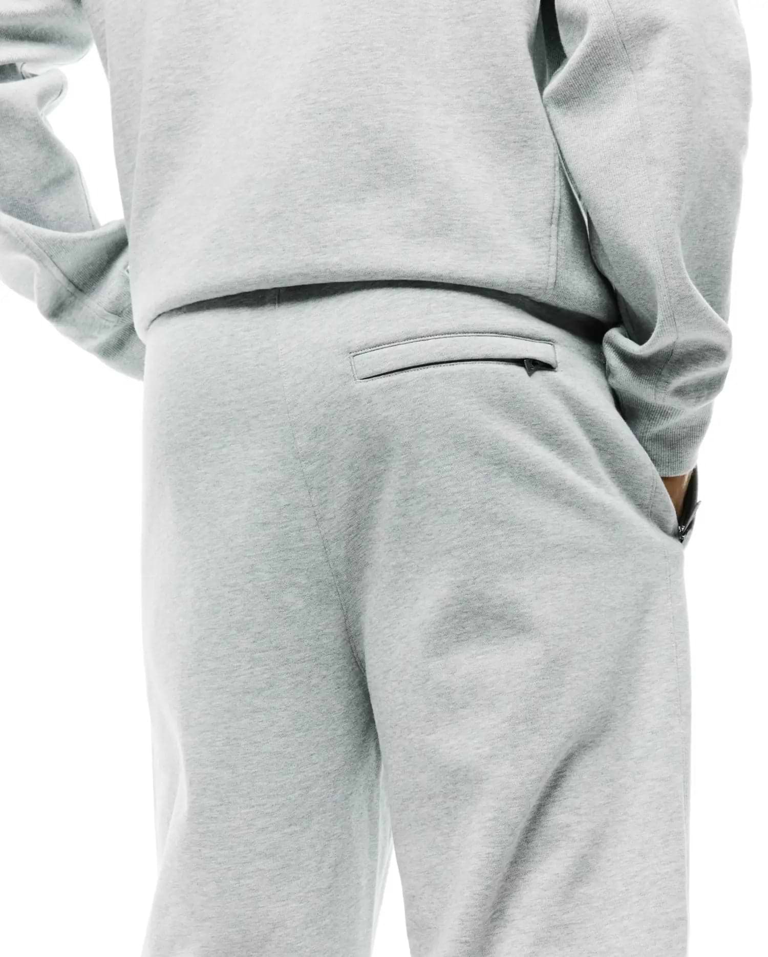Mens Terrence Brushed Fleece Sweatpant in light grey marl, offering a relaxed fit, soft brushed fleece texture, a zippered back pocket, and convenient side pockets.