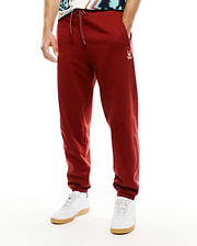 Mens Terrence Brushed Fleece Jogger in deep red, featuring a relaxed tapered fit, white drawstring, and small embroidered Psycho Bunny skull logo on the left thigh. (2)