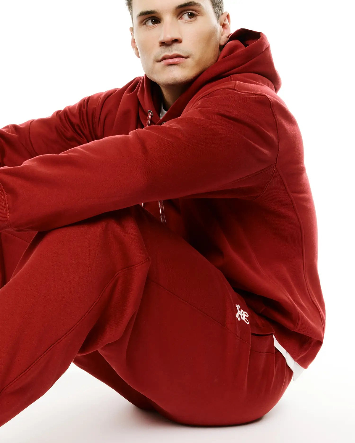 Deep red Mens Terrence Brushed Fleece Jogger and matching relaxed fit full-zip hoodie, both with ribbed cuffs. White embroidered Psycho Bunny skull logo on jogger's left thigh. (4)