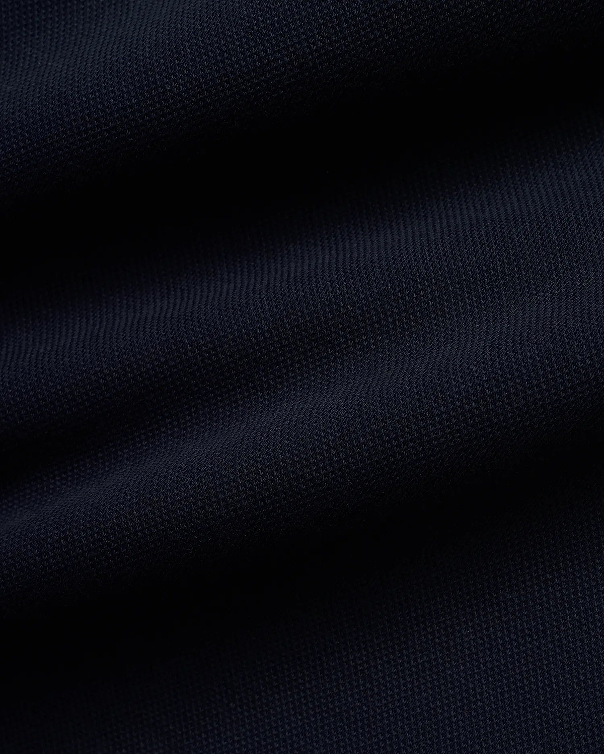 Rich, deep navy blue Pique fabric for the premium MEN'S JACQUES PIQUE TRACK PANTS, featuring a distinct, textured weave indicative of refined streetwear quality. (6)